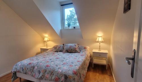1 dormitorio con 1 cama con 2 mesitas de noche y 2 lámparas en Lägenhet i villa, en Bålsta