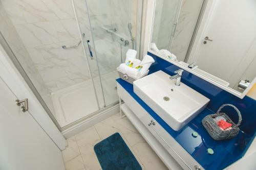 a bathroom with a sink and a shower at Orbi City Beach Hotel Batumi in Batumi