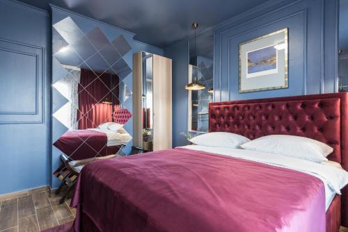 a bedroom with a red bed and blue walls at Apartments Marant - free private parking in Zadar