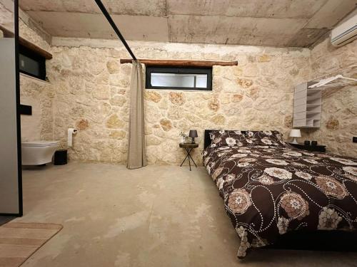 a bedroom with a bed and a bathroom with a tub at The Hermitage: Timeless charm&Beach&History nearby in Yenibosazici