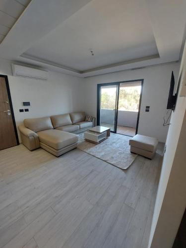 a living room with a couch and a table at The Wave residence Chott Meriam Sousse in El Ahmar