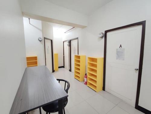 a conference room with a wooden table and chairs at Manila Real Residences Studio 8C in Manila