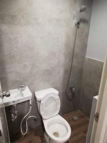 a bathroom with a toilet and a sink at Manila Real Residences Studio 8C in Manila