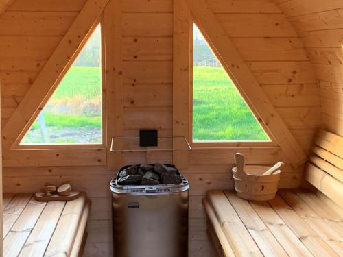 a room in a log cabin with two windows at Landhaus Scholz in Dollerup