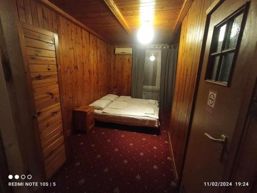 a small room with a bed and a door at Green House in Wola Przypkowska