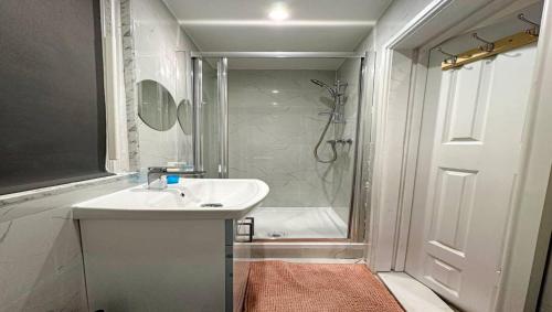 a bathroom with a sink and a shower at Lovely Studio Ealing in London