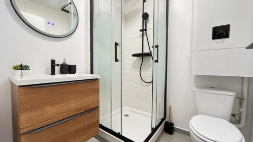 a bathroom with a shower and a toilet and a sink at Le bohème in La Houssaye-en-Brie