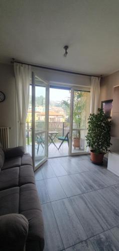 a living room with a couch and a sliding glass door at CASA VACANZE Matilde in Gavirate