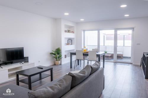 a living room with a couch and a table at Navio Beach Apartment Santa Cruz in Santa Cruz