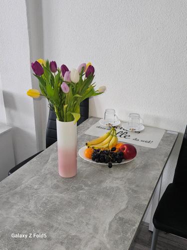 フライベルクにあるPrivate Zimmervermittlungの花瓶一皿と果物一皿