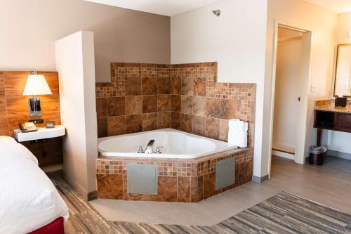 a bathroom with a bath tub in a room at Hampton Inn & Suites Scottsbluff in Scottsbluff
