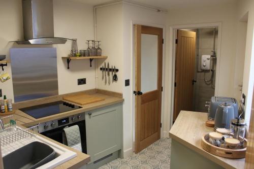 a kitchen with a sink and a counter top at Rose Cottage, Little Haven in Pembrokeshire