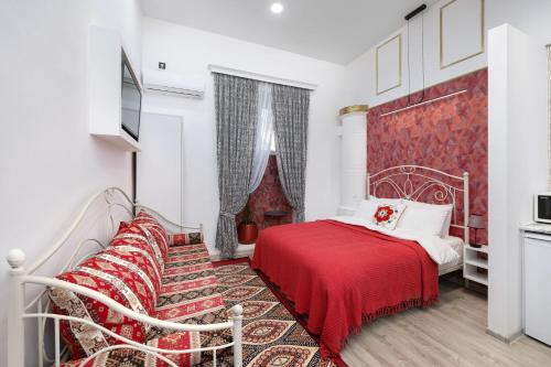 a bedroom with a bed and a red blanket at Studio in Old Tbilisi, Prime location, King Size Bed, AC, Heating in Tbilisi City