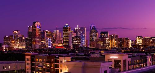 a nighttime view of a city skyline with at Canopy By Hilton Dallas Uptown in Dallas