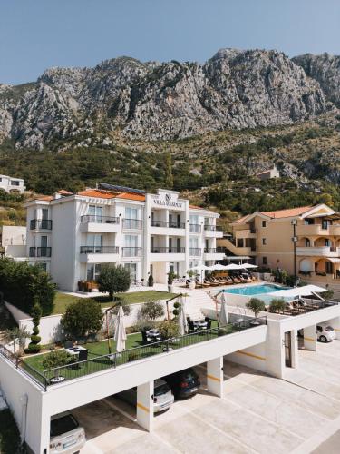 a view of a resort with a mountain in the background at Garden Recovery in Sveti Stefan