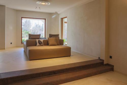 a couch in a living room with a window at Hotel Waldblick Kniebis in Kniebis