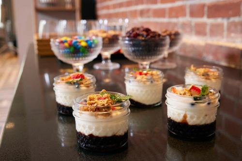 a group of desserts in jars on a table at Canopy By Hilton Columbus Downtown Short North in Columbus