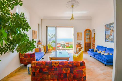 un salon avec des canapés bleus et une table dans l'établissement Un Balcon Sur La Mediterranée, à Marseille