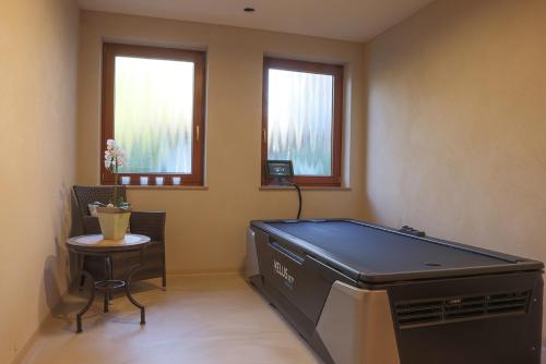 a room with a pool table and a table at Hotel Waldblick Kniebis in Kniebis