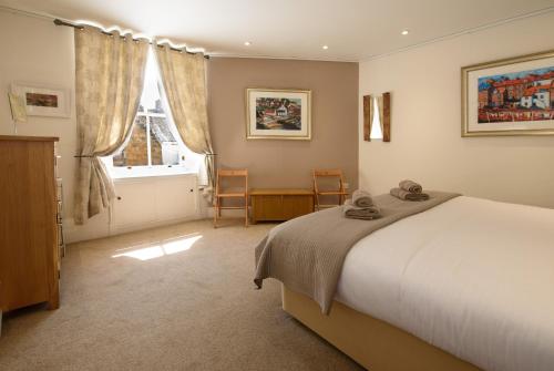 a bedroom with a large bed and a window at House on the Harbour Pittenweem in Pittenweem