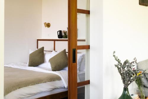 a bedroom with a bunk bed with white sheets at The Birdhouse Uluwatu 2BR Treetop Private Home with Deep Plunge Pool in Uluwatu