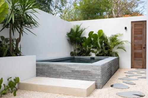 a hot tub in the middle of a garden at The Birdhouse Uluwatu 2BR Treetop Private Home with Deep Plunge Pool in Uluwatu