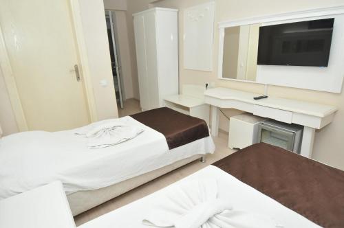 Un ou plusieurs lits dans un hébergement de l'établissement YILDIZHAN HOTEL
