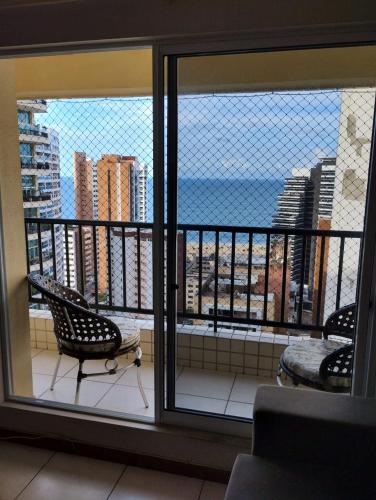 a room with a view of the ocean from a balcony at Villa damasco in Fortaleza
