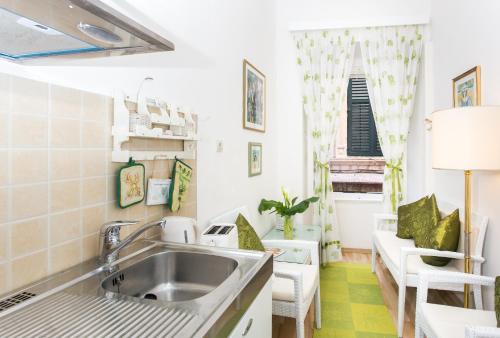a kitchen with a sink and a couch at Apartments Adriana Flora in Dubrovnik