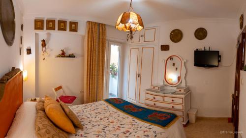 マラガにあるLa Casa de La Abuela Rosyのベッドルーム1室(ベッド1台、ドレッサー、鏡付)