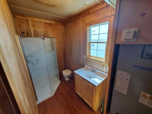a bathroom with a shower and a sink and a toilet at Baffin Bay Penthouse in Corpus Christi