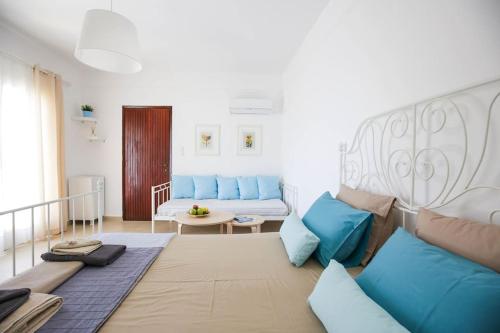 a living room with blue pillows and a couch at The cozy nest:) in Batsi