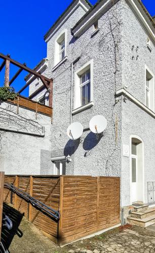 a house with two satellite dishes on the side of it at Komfortowy apartament z tarasem w pobliżu jeziora i Gór Sowich in Bielawa