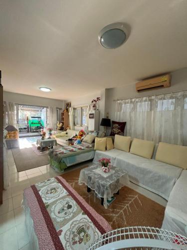 a living room with a couch and a table at Soft Power Host House in Ban Ko