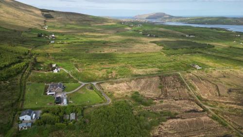 an aerial view of a field with houses on a hill at Valentia View in Portmagee