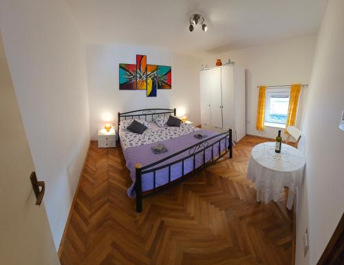 a bedroom with a bed and a table in it at Apartment 22 Omiš in Omiš