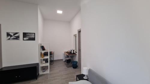 a living room with a couch and a tv at Via Contu in Iglesias