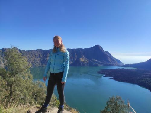 a woman standing on a hill overlooking a lake at Tastura Homestay in Praya