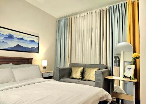 a hotel room with a bed and a chair at Guest Favorite House in Biñan in Biñan
