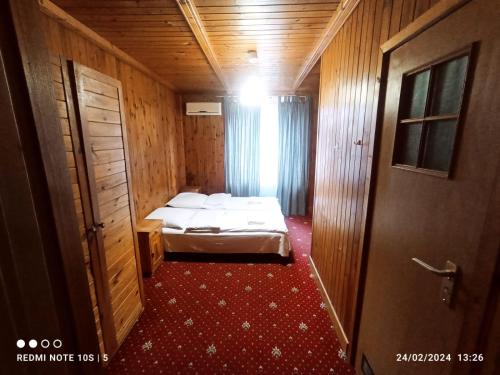 a small room with a bed and a door at Green House in Wola Przypkowska