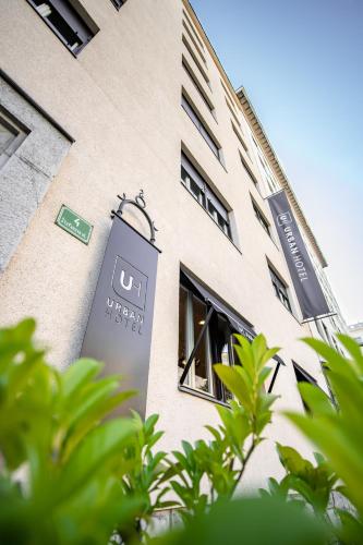 a building with a sign on the side of it at Urban Boutique Hotel Center in Ljubljana
