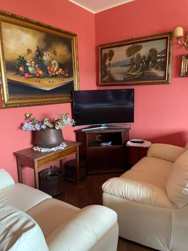 a living room with two couches and a flat screen tv at Villa Giacomina in Fasano