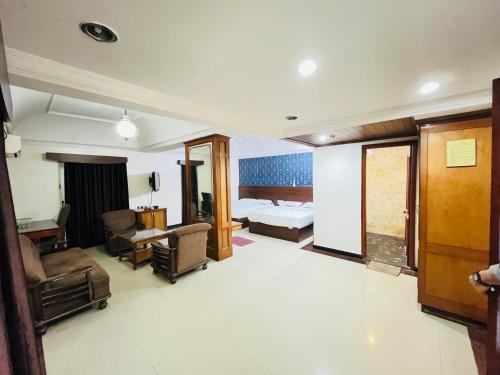 a hotel room with a bed and a bedroom at Hotel Chetan International in Bangalore