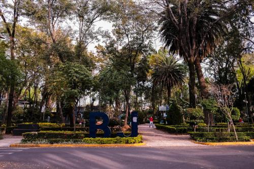 a park with a sign in the middle of the road at Urban Style Retreat, Rooftop Views, CDMX 4 in Mexico City