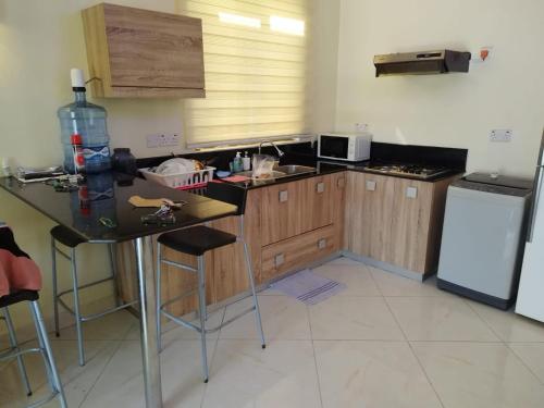 a kitchen with wooden cabinets and a black counter top at Villa 1428 in Grand Baie