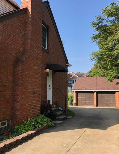 un bâtiment en briques avec une porte blanche et un garage dans l'établissement Private suite near Cleveland Clinic, à Shaker Heights