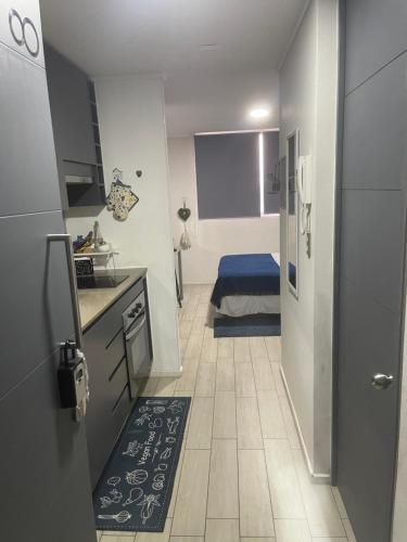 a small kitchen with a sink and a refrigerator at Departamento en Santiago centro cerca de movistar arena, Caupolican in Santiago