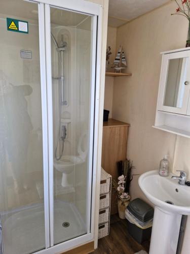 a bathroom with a shower and a sink at 35 Irby way in Skegness