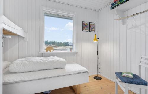 a white bedroom with a bed and a window at Awesome Home In Brovst With Wifi in Brovst