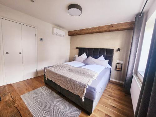 a bedroom with a large bed and a large window at Boutique Hotel Marielle in Bad Münstereifel